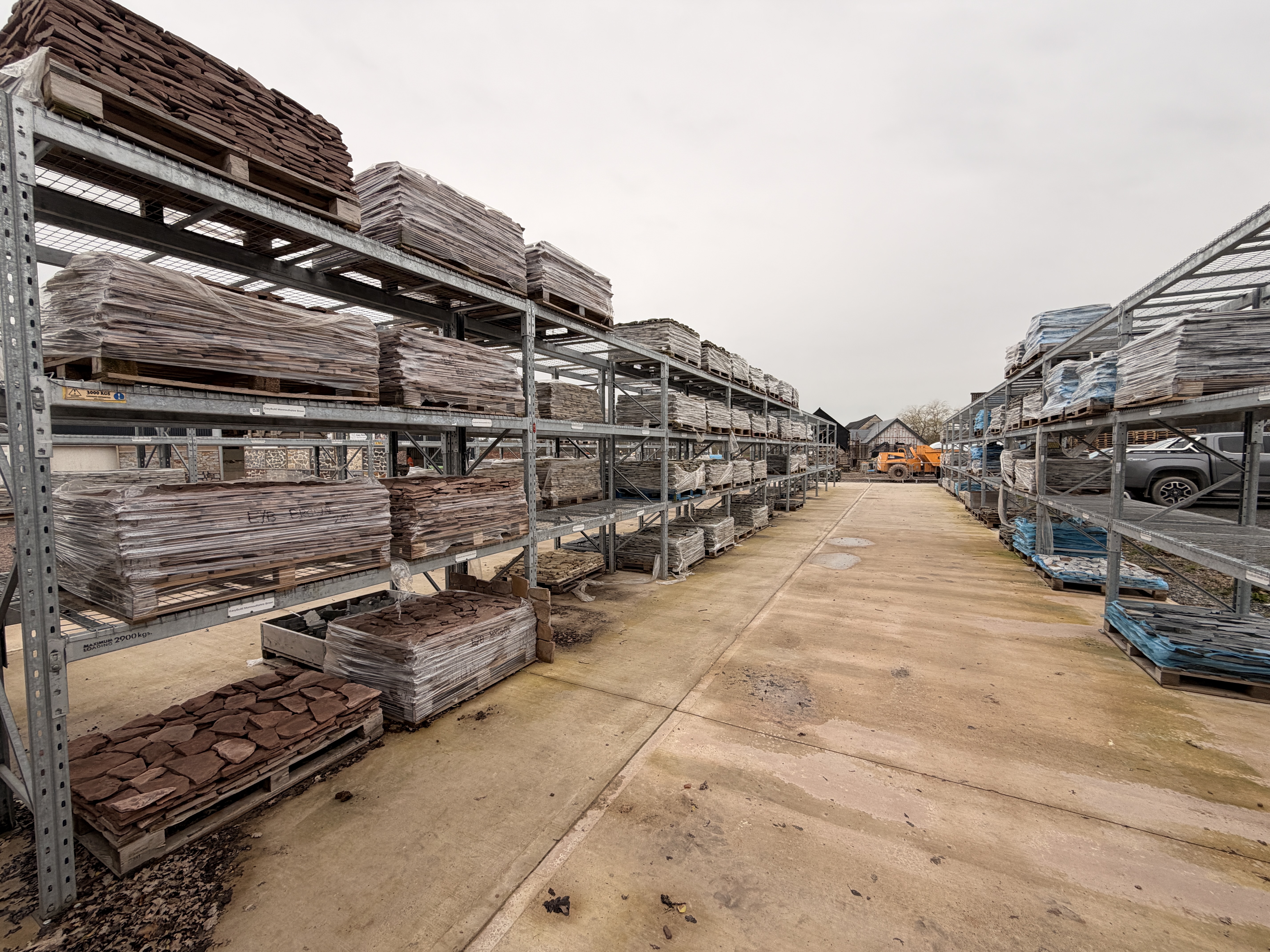 Stone cladding pallets stacked on industrial racking at Easy Build Stone's Herefordshire yard